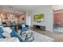 Open concept living area with a modern sofa, leading to a kitchen and a balcony offering city views at 400 W North St # 1134, Raleigh, NC 27603