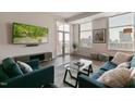 Comfortable living room with a contemporary design, filled with natural light from the large windows and a balcony at 400 W North St # 1134, Raleigh, NC 27603