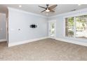 Spacious living room with modern ceiling fan, neutral carpet and natural light from the window at 412 Waterford Lake Dr, Cary, NC 27519