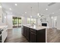 Modern open kitchen with stainless steel appliances, a stylish island and an adjacent living space at 425 Shadow Falls Dr, Wendell, NC 27591