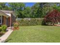 Large grassy backyard, ideal for outdoor activities, surrounded by privacy landscaping and mature trees at 4300 Edgehill Ct, Raleigh, NC 27612