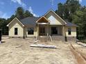 New construction home showing siding, brick foundation, and porch with stone steps to front door at 5021 Mitchell Town Rd, Youngsville, NC 27596