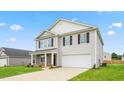 Well-maintained two-story home with gray siding, a two-car garage, and a freshly paved driveway at 525 Lochalsh Dr, Gibsonville, NC 27249