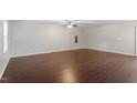Spacious living room featuring sleek wood floors, neutral walls, and a modern ceiling fan at 5613 Deerborn Dr, Apex, NC 27539