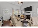 Inviting living room featuring a fireplace, lots of natural light, and an open floor plan at 60 Northdale Ct, Louisburg, NC 27549
