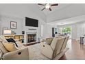 Bright living room features a fireplace, vaulted ceiling, and seamless flow to the dining area at 60 Northdale Ct, Louisburg, NC 27549