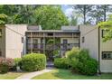 Exterior of a two-story condo unit with wood siding, screened porches, and landscaped walkway and lawn at 629 Pine Ridge Pl, Raleigh, NC 27609