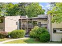 Exterior of a two-story condo unit with wood siding, screened porches, and landscaped walkway and lawn at 629 Pine Ridge Pl, Raleigh, NC 27609