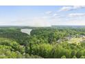 Breathtaking aerial view of a lake surrounded by lush greenery and charming homes at 7116 Incline Dr, Wake Forest, NC 27587
