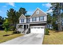 Beautiful two-story home featuring a welcoming covered porch and attached garage at 7729 Calcutta Dr, Willow Springs, NC 27592