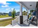 Cozy front porch featuring comfortable seating, decorative accents, and a view of the neighborhood at 7729 Calcutta Dr, Willow Springs, NC 27592