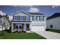 Charming two-story home featuring gray siding, black shutters, and an attached two-car garage at 85 Cordoba Dr, Franklinton, NC 27525