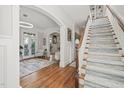 Elegant foyer featuring hardwood floors, staircase and arched doorways to other rooms at 8524 Society Pl, Raleigh, NC 27615