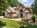 Beautiful house featuring stone, complementary siding, professional landscaping and a manicured lawn at 901 Edgewater Dr, Garner, NC 27529