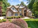 Attractive home with stone details, well-kept lawn and landscaping with blue sky backdrop at 901 Edgewater Dr, Garner, NC 27529