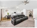 Spacious living room featuring vaulted ceilings and an open floor plan to dining and kitchen at 1004 Gold Cir, Mebane, NC 27302