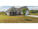Beautiful home showcasing a well-maintained lawn and inviting curb appeal at 105 Seminole Fields Dr, Broadway, NC 27505