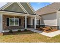 Inviting entryway with brick accents, lush landscaping, and a welcoming walkway at 105 Seminole Fields Dr, Broadway, NC 27505