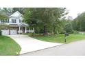 Suburban home with a well-manicured lawn and long driveway leading to the front entrance at 106 N Duelling Oaks Dr, Chapel Hill, NC 27517