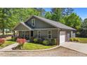 Attractive home featuring an attached garage, welcoming porch, and landscaped front yard at 109 Rustler Rd, Louisburg, NC 27549