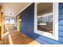 Inviting front porch showcasing a vibrant yellow door, complemented by stylish light fixtures and a cozy welcome mat at 1100 Chester St, Durham, NC 27701