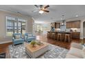 Open concept living room and kitchen with island seating and stainless steel appliances at 115 Moss Creek Pl, Fuquay Varina, NC 27526