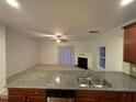 Bright living room featuring a fireplace, neutral carpet, a ceiling fan, and sliding door to the exterior at 1304 Cozart St # 109, Durham, NC 27704