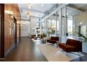 Grand lobby with elevators, tile floor, seating, a high ceiling, and large windows at 140 W Franklin St # 706, Chapel Hill, NC 27516