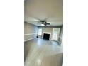 Spacious living room featuring modern floors, fireplace, lots of natural light, and a ceiling fan at 15 Colonial Hills Dr, Lillington, NC 27546
