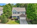 Charming two-story home with a stone accent, well-manicured lawn, surrounded by mature trees at 1608 Hayesville Dr, Fuquay Varina, NC 27526