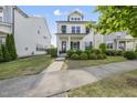 Charming two-story home boasts a welcoming porch and meticulously maintained lawn at 1616 Silo Ridge Dr, Wake Forest, NC 27587