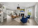 Spacious living room with fireplace, hardwood floors, and modern furnishings at 1616 Silo Ridge Dr, Wake Forest, NC 27587