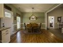 Charming dining room with hardwood floors, a large window, and a decorative light fixture at 199 Courtney Ln, Dunn, NC 28334