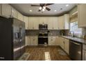 Well-lit kitchen features stainless steel appliances and updated cabinets, backsplash, and countertops at 199 Courtney Ln, Dunn, NC 28334