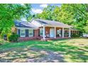 Beautiful brick home with a welcoming front porch, perfect for enjoying the outdoors at 206 Kittys Ln, Erwin, NC 28339