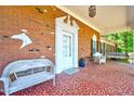 Cozy covered front porch features decorative tile, seating, and a charming swing at 206 Kittys Ln, Erwin, NC 28339