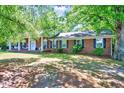 Lovely brick home showcasing mature trees and a covered front porch with classic appeal at 206 Kittys Ln, Erwin, NC 28339