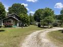 Landscaped front yard and charming home set back from the road at 209 E Winston St, Youngsville, NC 27596