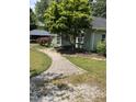 Quaint home featuring a landscaped yard and a charming walkway to the front porch at 209 E Winston St, Youngsville, NC 27596