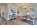 Bright dining room features a modern chandelier and stylish decor, and wood flooring at 215 Graduate Ct, Durham, NC 27713