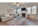 Cozy living room with a fireplace, plush seating, and ample natural light at 215 Graduate Ct, Durham, NC 27713