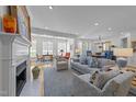 Spacious living room with fireplace, elegant furnishings, and plenty of natural light at 2701 Glenwood Gardens Ln, Raleigh, NC 27608