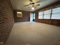 A bright living room featuring brick accent wall and carpeted floors at 2710 Delaney Dr, Burlington, NC 27215