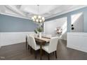 Dining room featuring a decorative ceiling, hardwood floors, and ample seating with stylish, neutral-colored chairs at 277 High Ridge Ln, Pittsboro, NC 27312