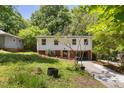 Two-story home with green lawn, red brick base, and an asphalt driveway at 2904 Sprucewood Dr, Durham, NC 27707