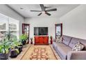 Cozy living room featuring neutral walls, hardwood floors, a ceiling fan, and comfortable seating at 2923 Cullens Dr, Graham, NC 27253