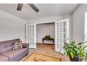 Comfortable living room featuring a couch, hardwood floors, and a view of an adjacent room through double doors at 2923 Cullens Dr, Graham, NC 27253