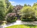 A charming two-story brick home with a neatly landscaped yard and symmetrical design at 3203 Rugby Rd, Durham, NC 27707