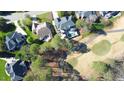 An aerial view depicts a home with a pool next to a golf course fairway at 325 Hogans Valley Way, Cary, NC 27513