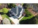 Aerial view of a house featuring a gray roof, a basketball court, and green landscaping at 325 Hogans Valley Way, Cary, NC 27513